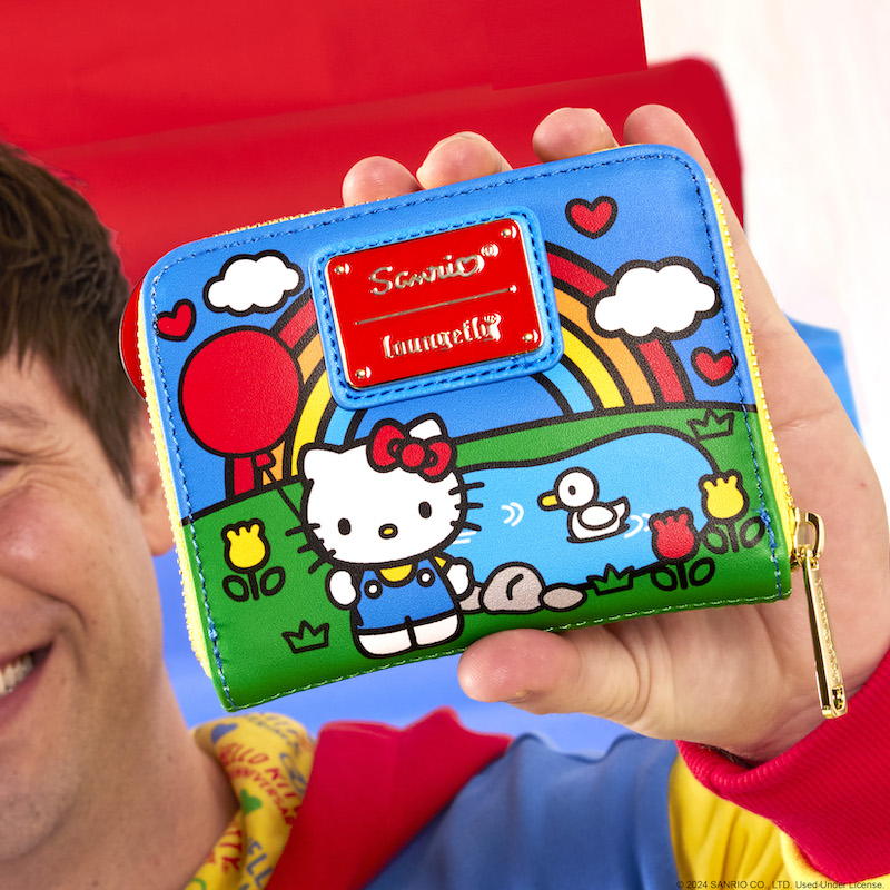 Man holding the Loungefly Sanrio Hello Kitty 50th Anniversary Zip Around Wallet, showing off the back side of the wallet 